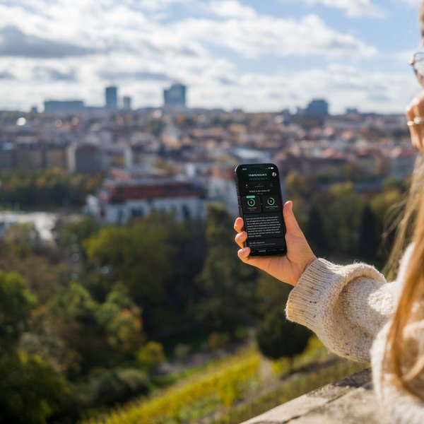Checking Terpenology on a phone with a city view